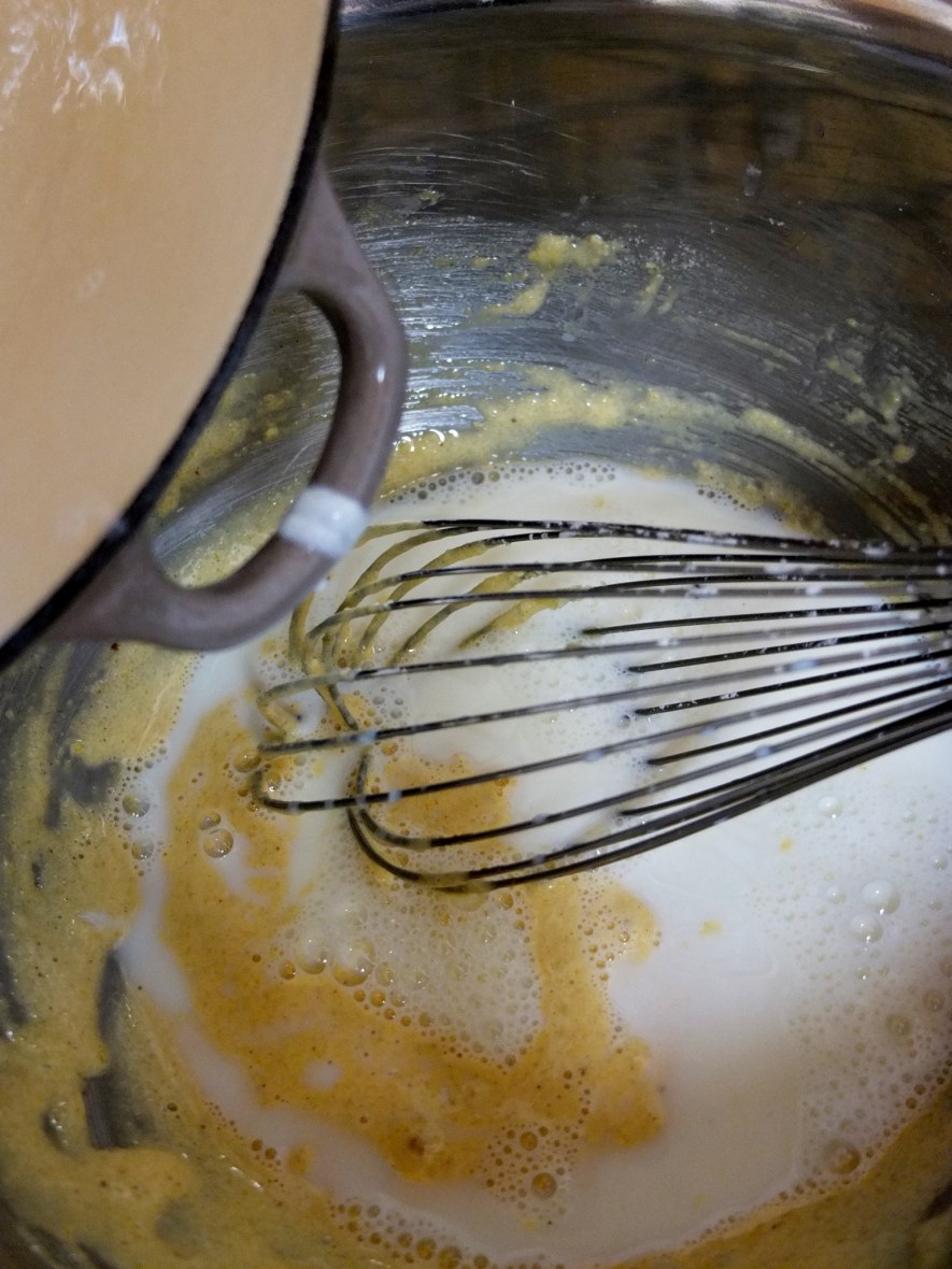 Pour the warm milk into the large bowl while whisking.