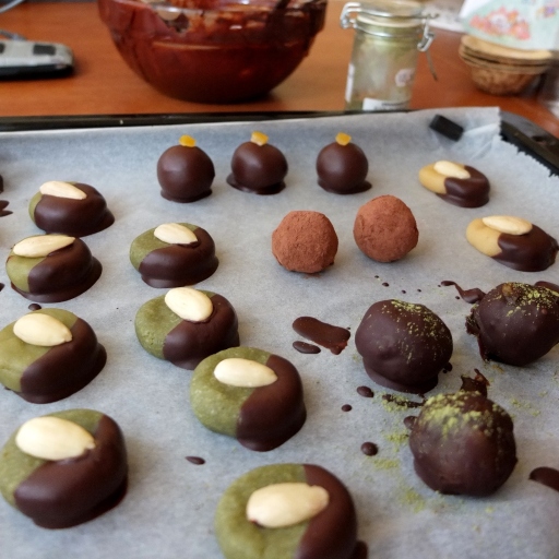 Covering the marzipans and caramels in chocolate
