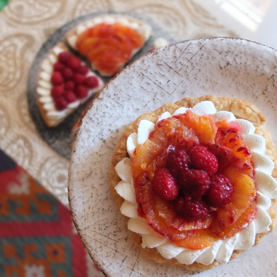 Fresh fruit and cream puff pastry tarts - with raspberries and blood oranges