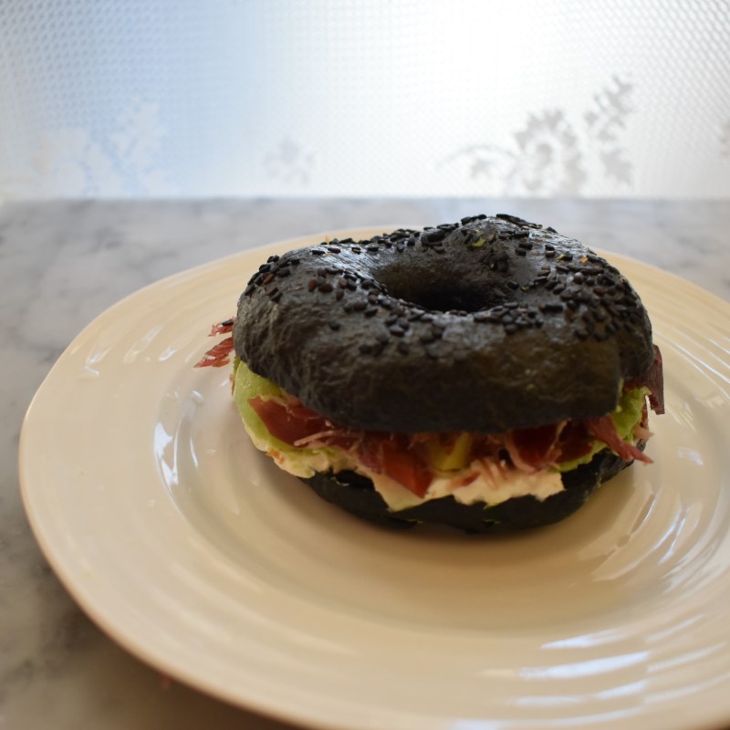 Activated charcoal sourdough bagel with cured ham