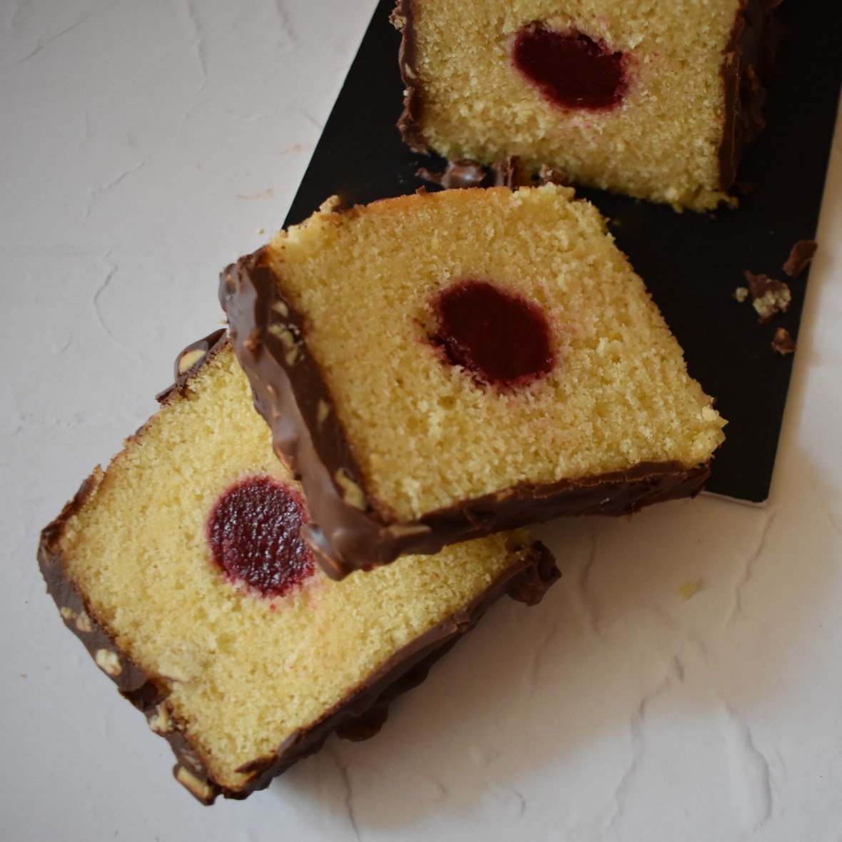 Holey Moley lemon surprise cake with raspbery insert and rocher chocolate glaçage