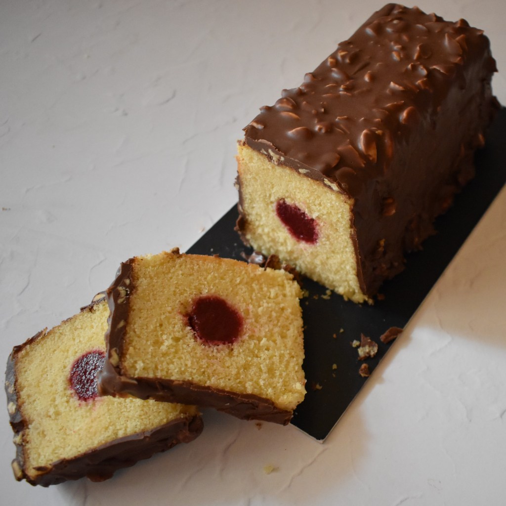 Holey Moley lemon surprise cake with raspbery insert and rocher chocolate glaçage