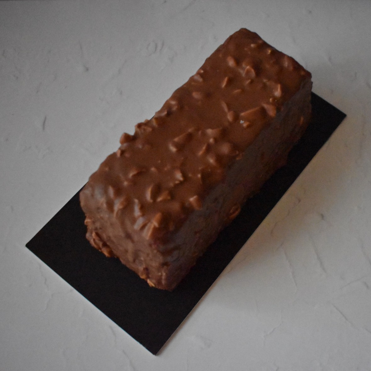 Holey Moley lemon surprise cake with raspbery insert and rocher chocolate glaçage