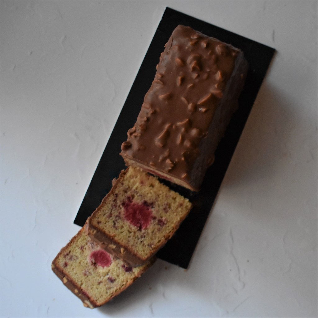 Holey Moley lemon surprise cake with raspbery insert and rocher chocolate glaçage