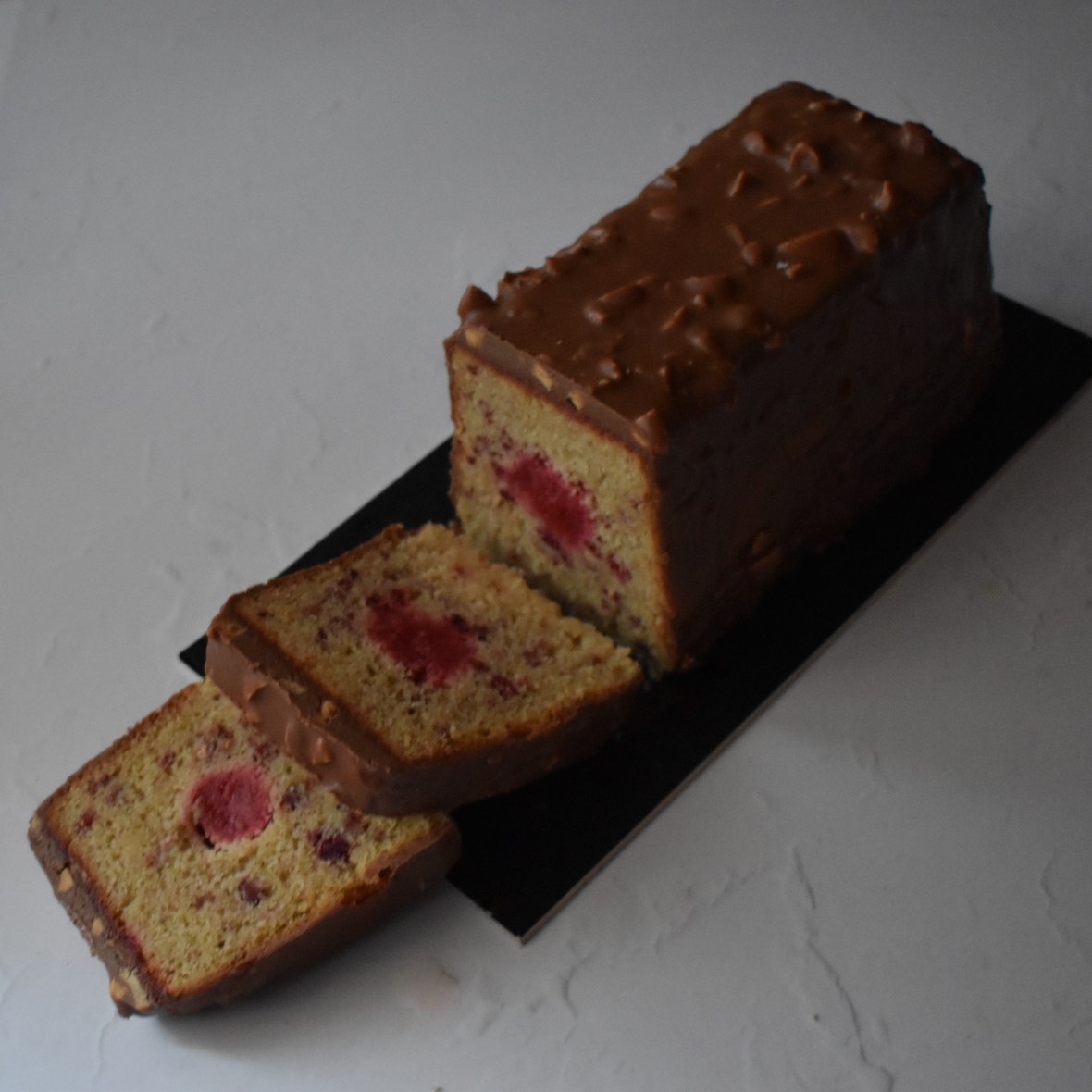 Holey Moley lemon surprise cake with raspbery insert and rocher chocolate glaçage