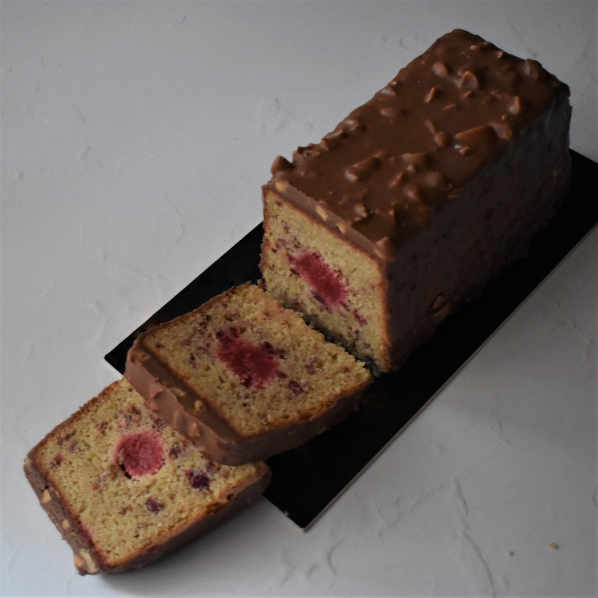 Holey Moley lemon surprise cake with raspbery insert and rocher chocolate glaçage