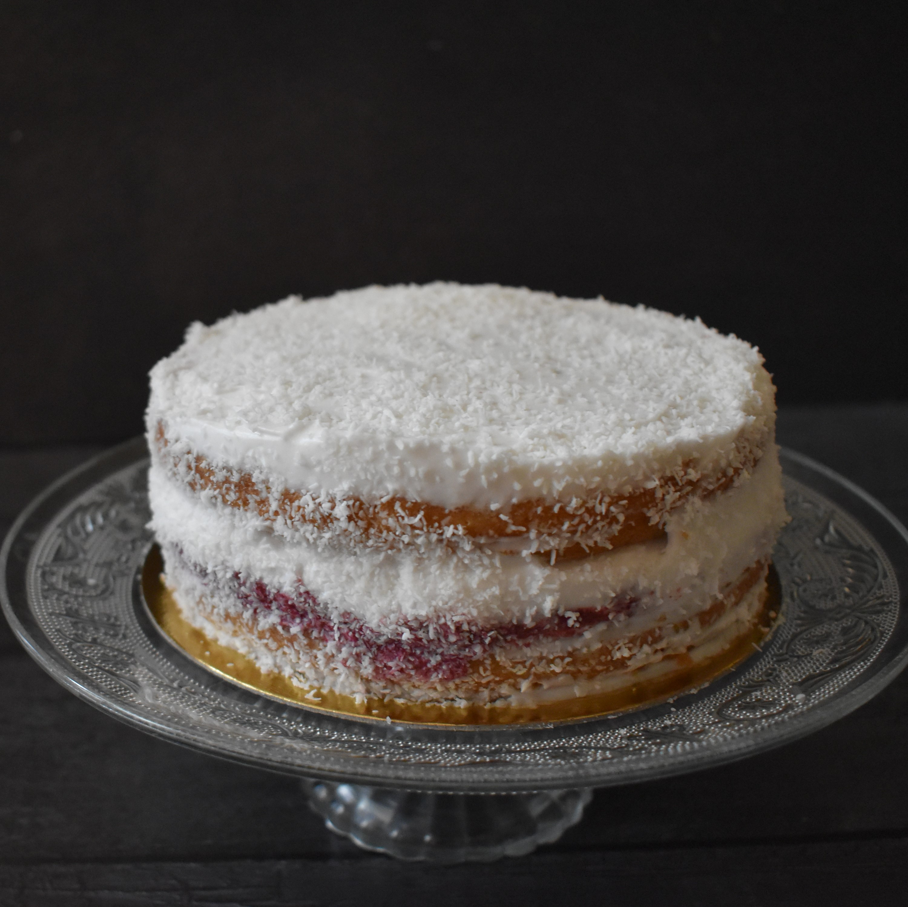 Snowy love vegan layer cake with blackcurrant curd and coconut buttercream