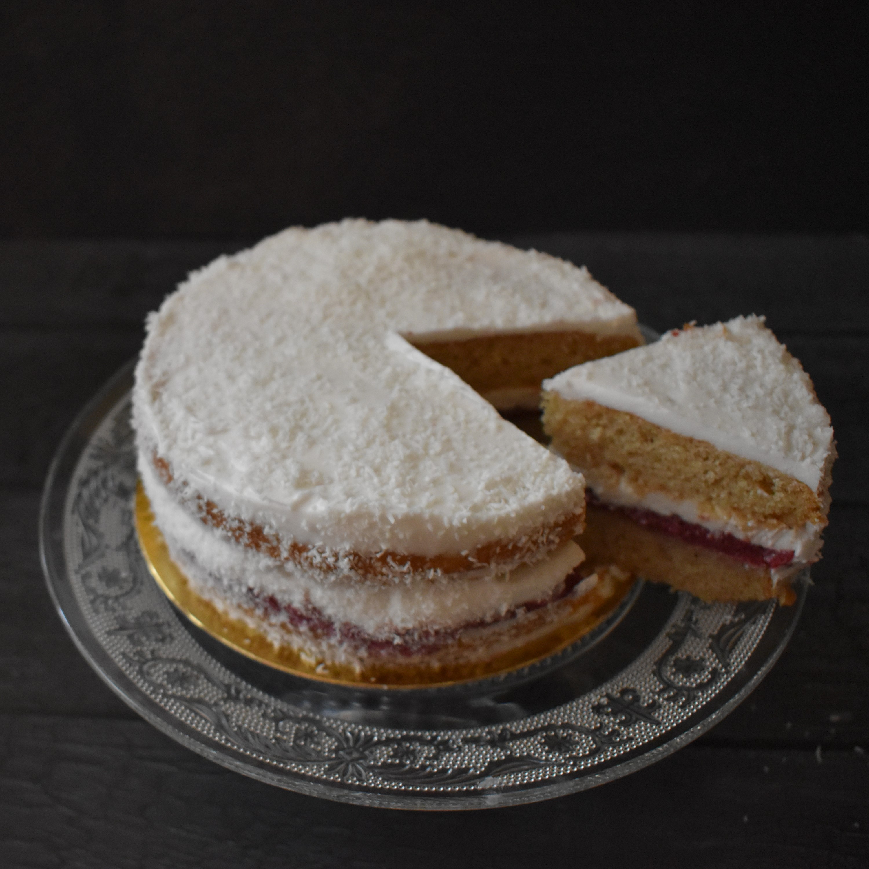 Snowy love vegan layer cake with blackcurrant curd and coconut buttercream