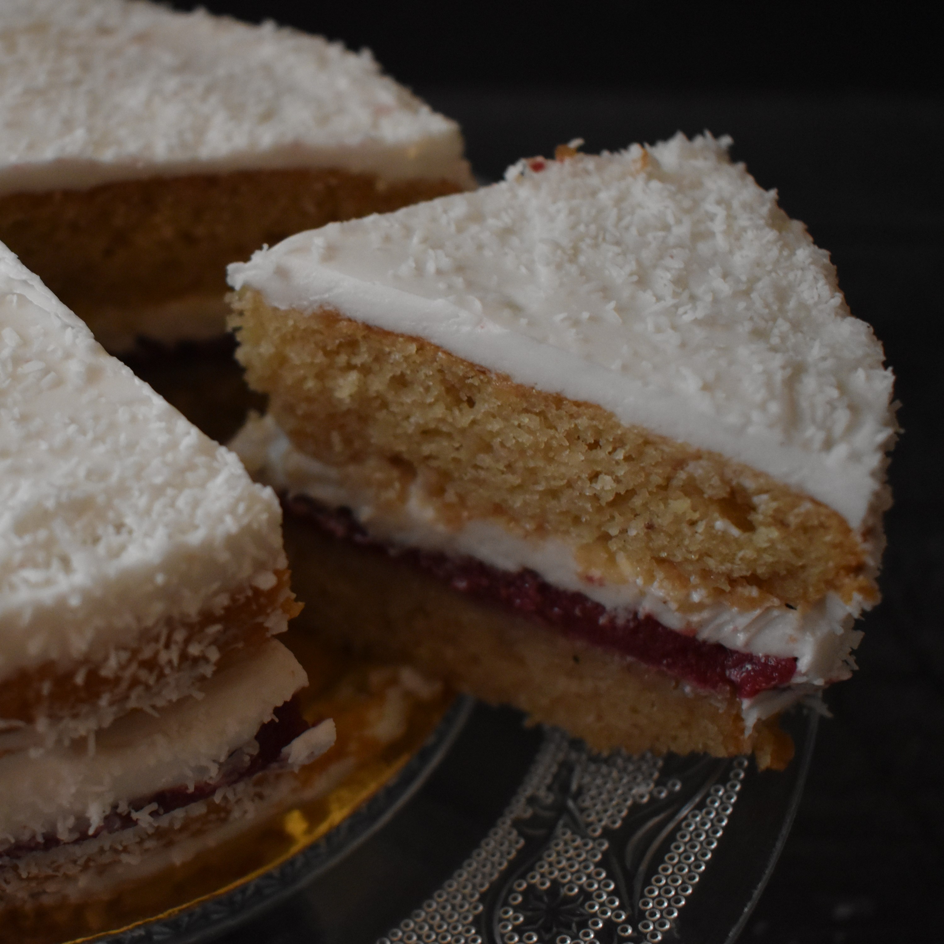 Snowy love vegan layer cake with blackcurrant curd and coconut buttercream